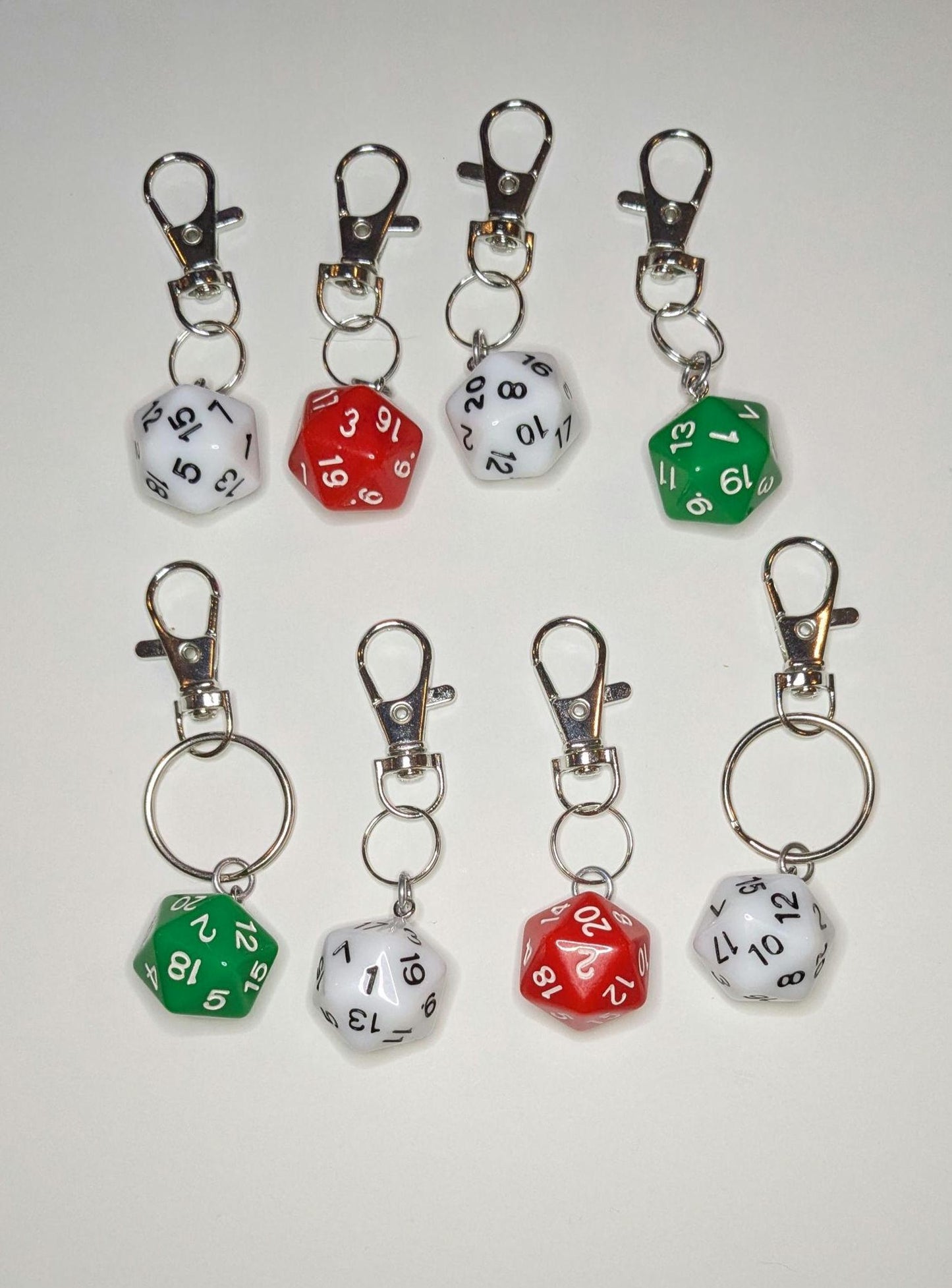 A collection of D20 keychain bag clips in red and green, with metal clips and rings, displayed against a white background.