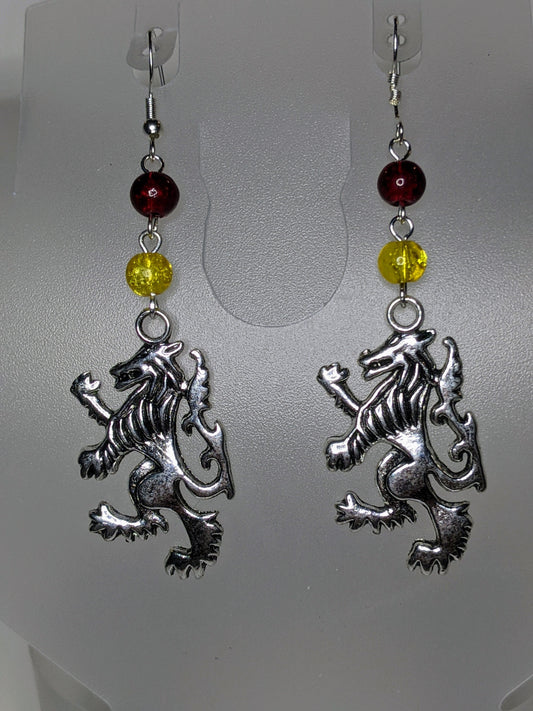 Close up of silver lions rampant facing left wirh red & yellow crackle glass bead accents