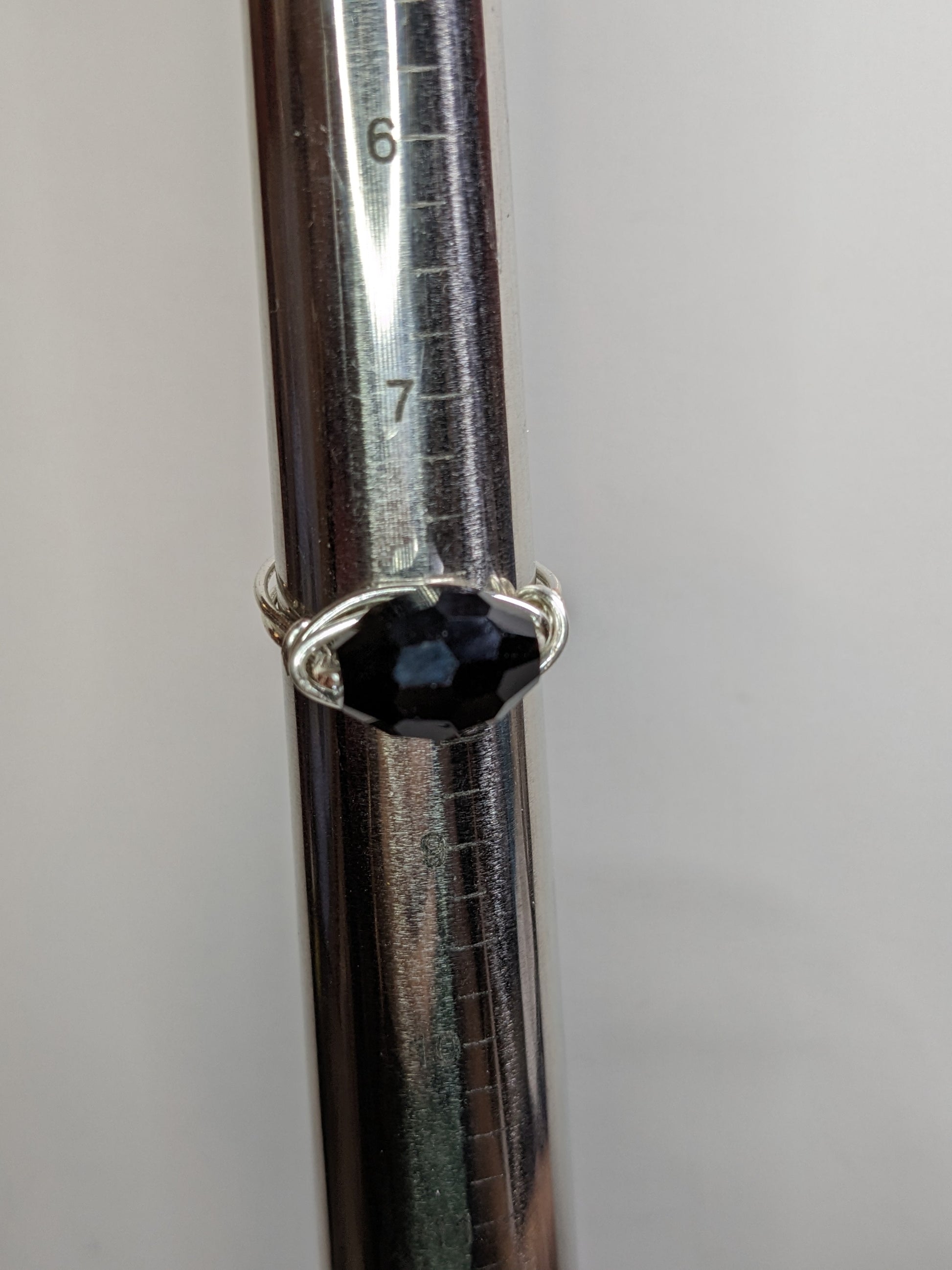 Wire wrapped wring on a mandrel showing the ring is US size 8