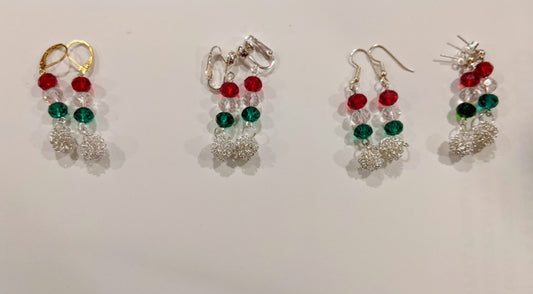 A collection of festive dangle earrings with silver chain and multicolored glass beads displayed against a white background.