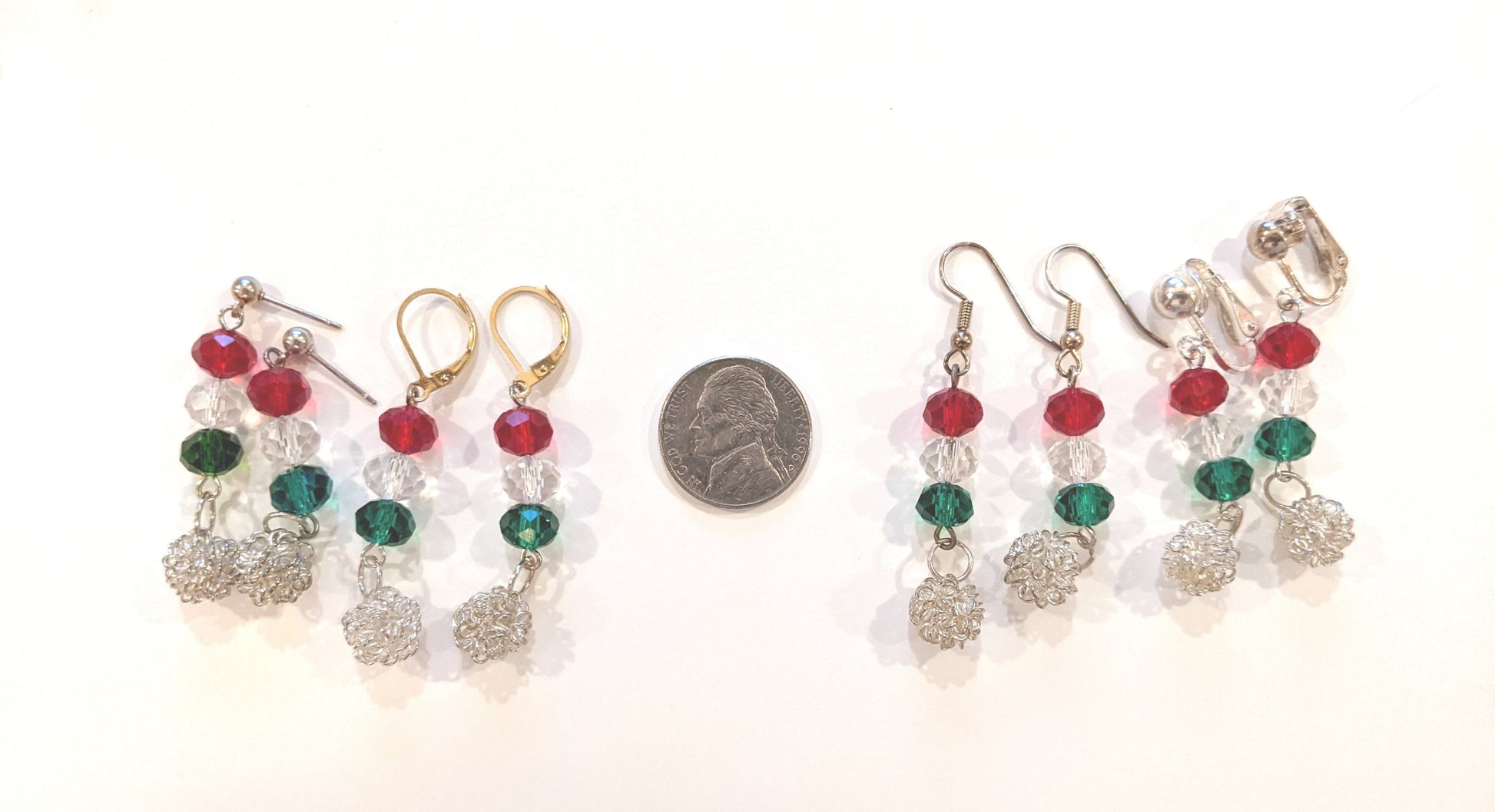 Festive dangle earrings displayed with a US nickel to show size.