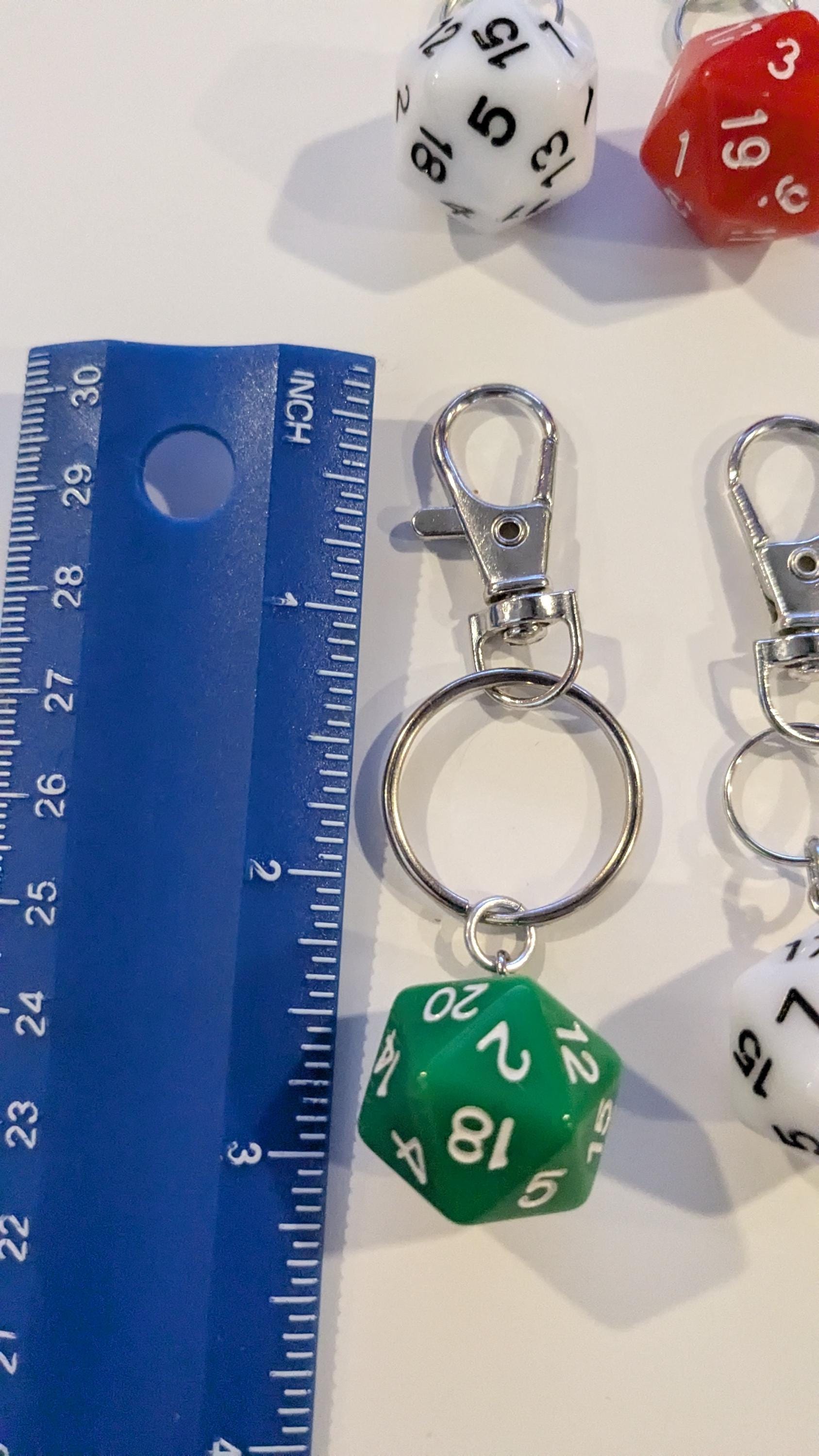 D20 key chain next to a blue ruler showing the key chain is 3 inches long