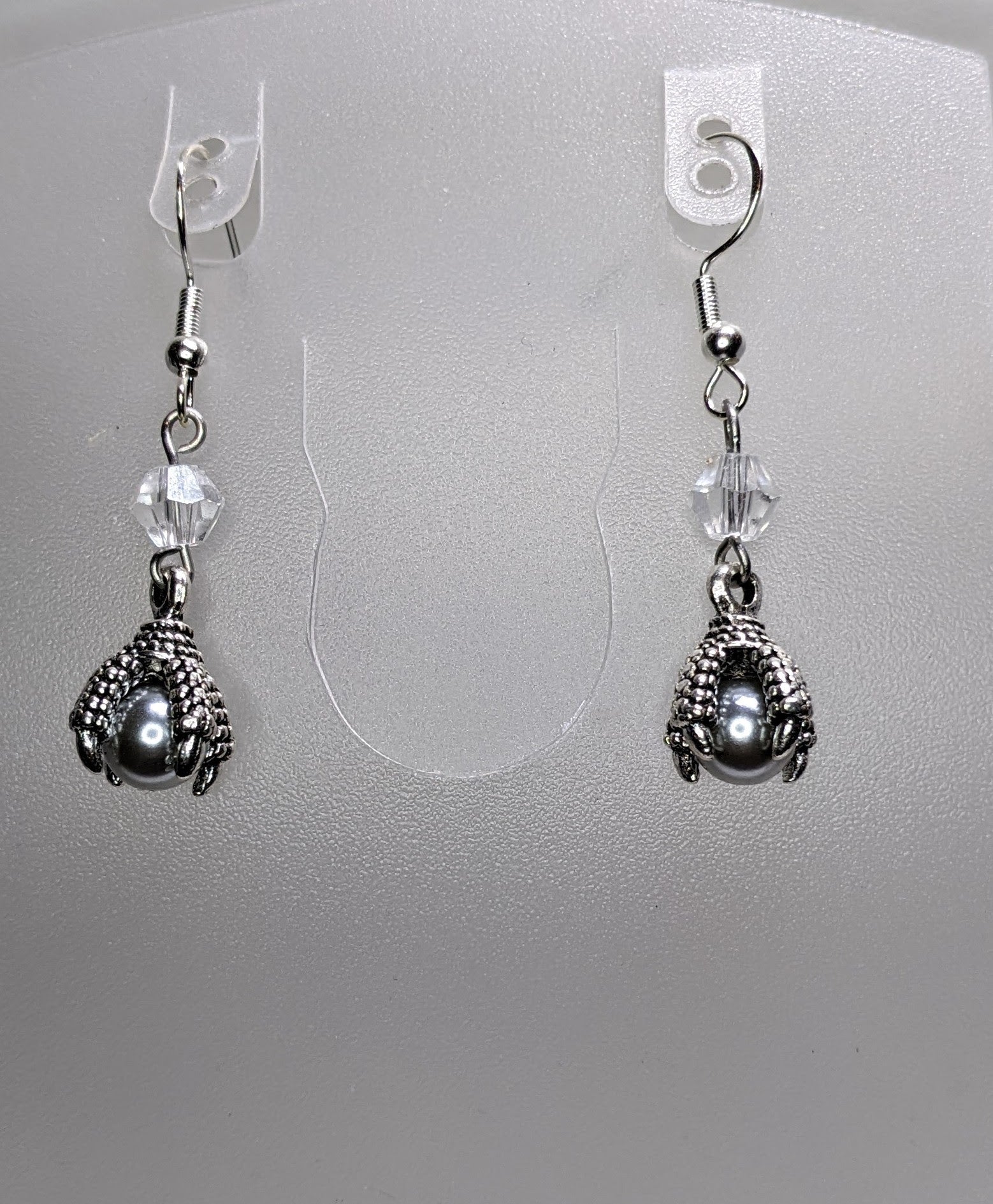 Silver dragon claw earrings with silver pearls in the claw and crystal bi cone accent