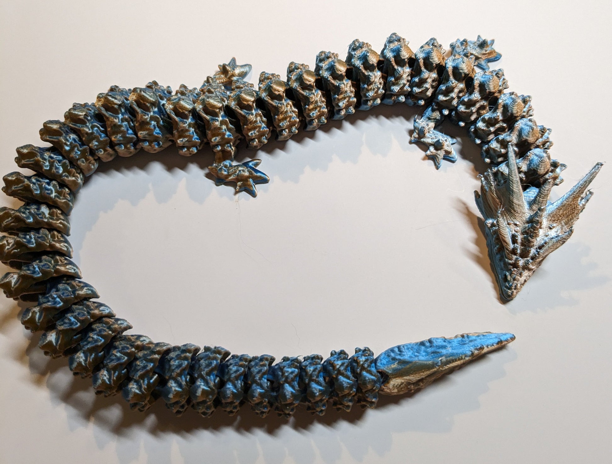 Gold and blue articulated 3D printed dragon