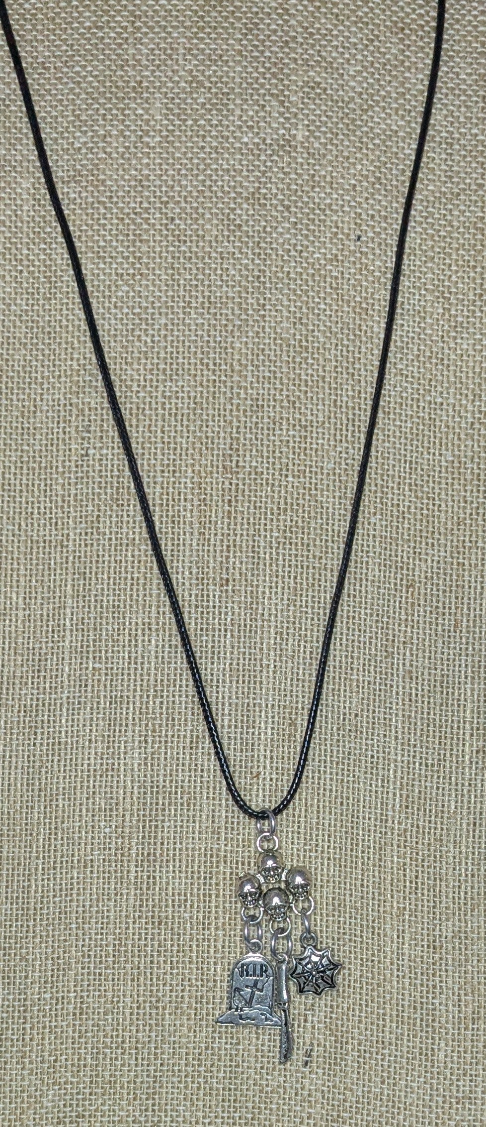 Necklace with charms on a textured surface