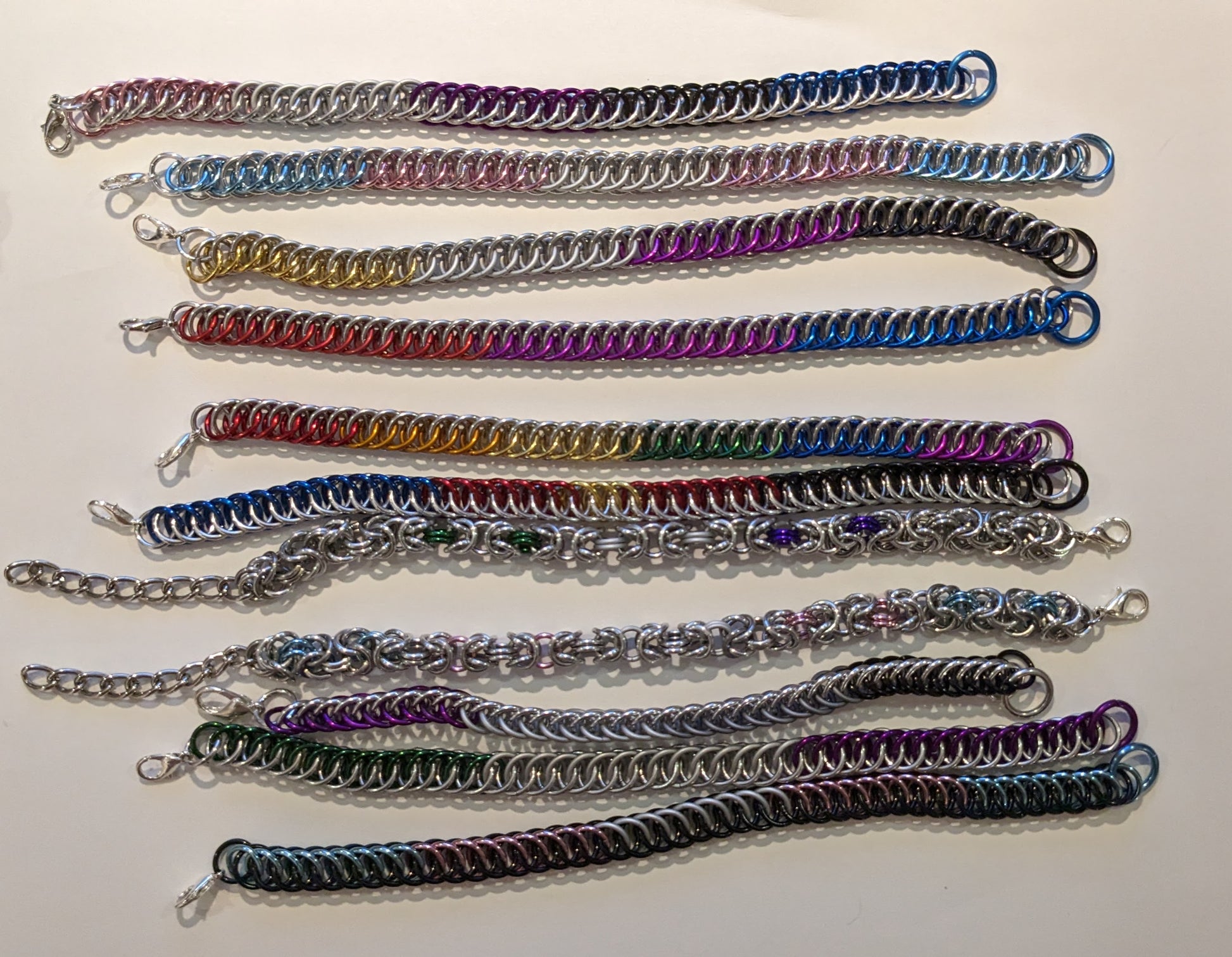 Set of colorful chainmail bracelets on a white background